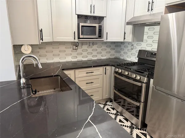 a kitchen with a stove a microwave and a refrigerator
