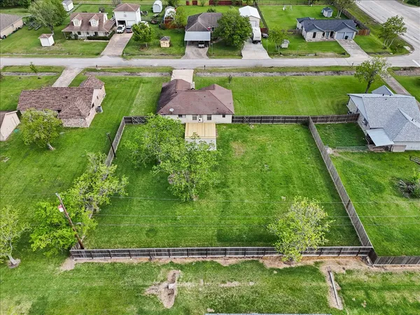 an aerial view of a house with a garden and swimming pool