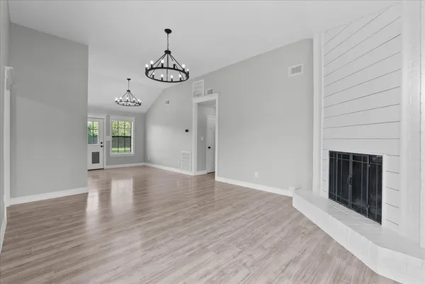 a view of an entryway with wooden floor