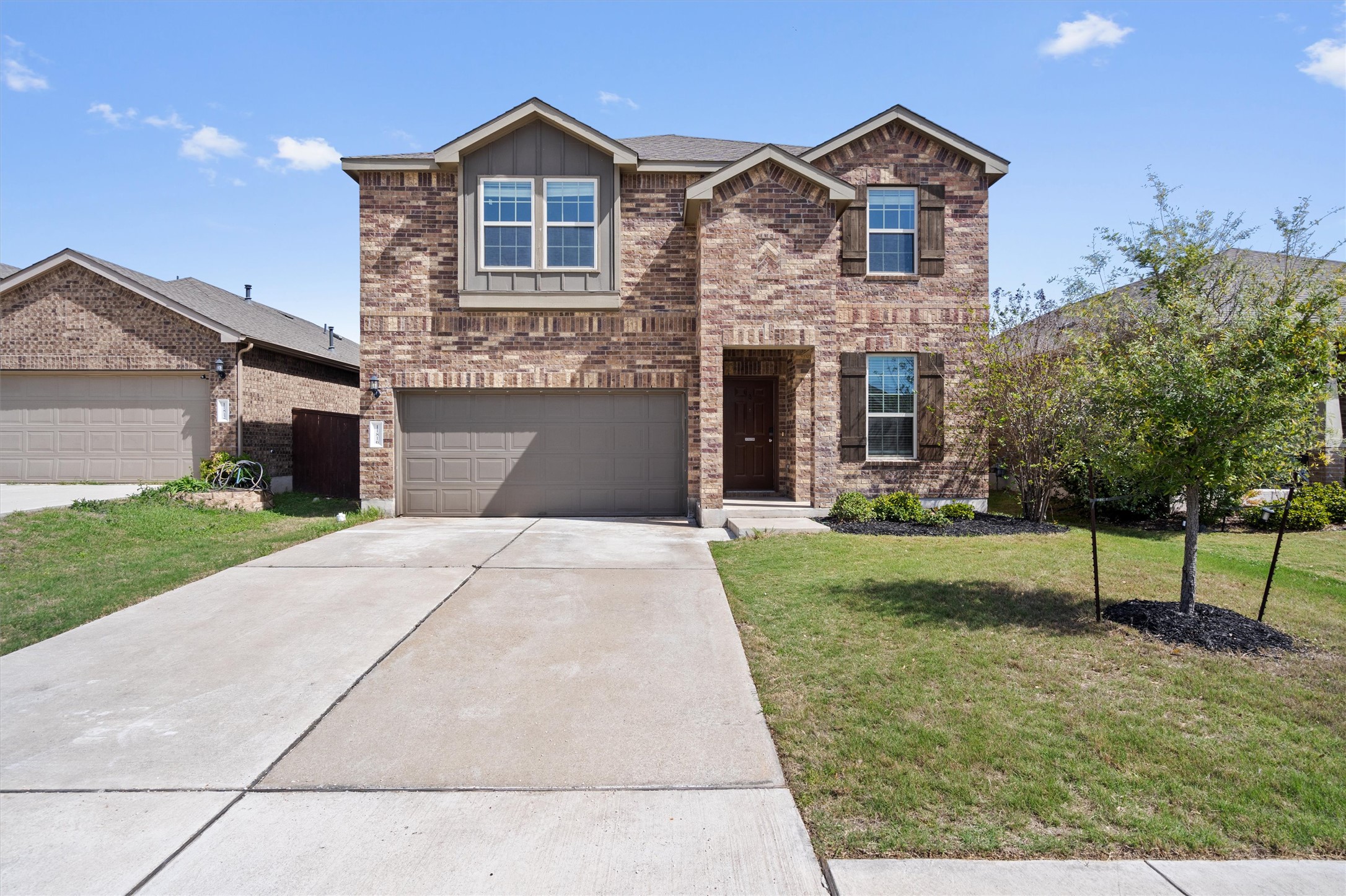 11816 Jackson Fls Way Manor, TX 78653 - Photo 1 of 40 a front view of a house with a yard and garage