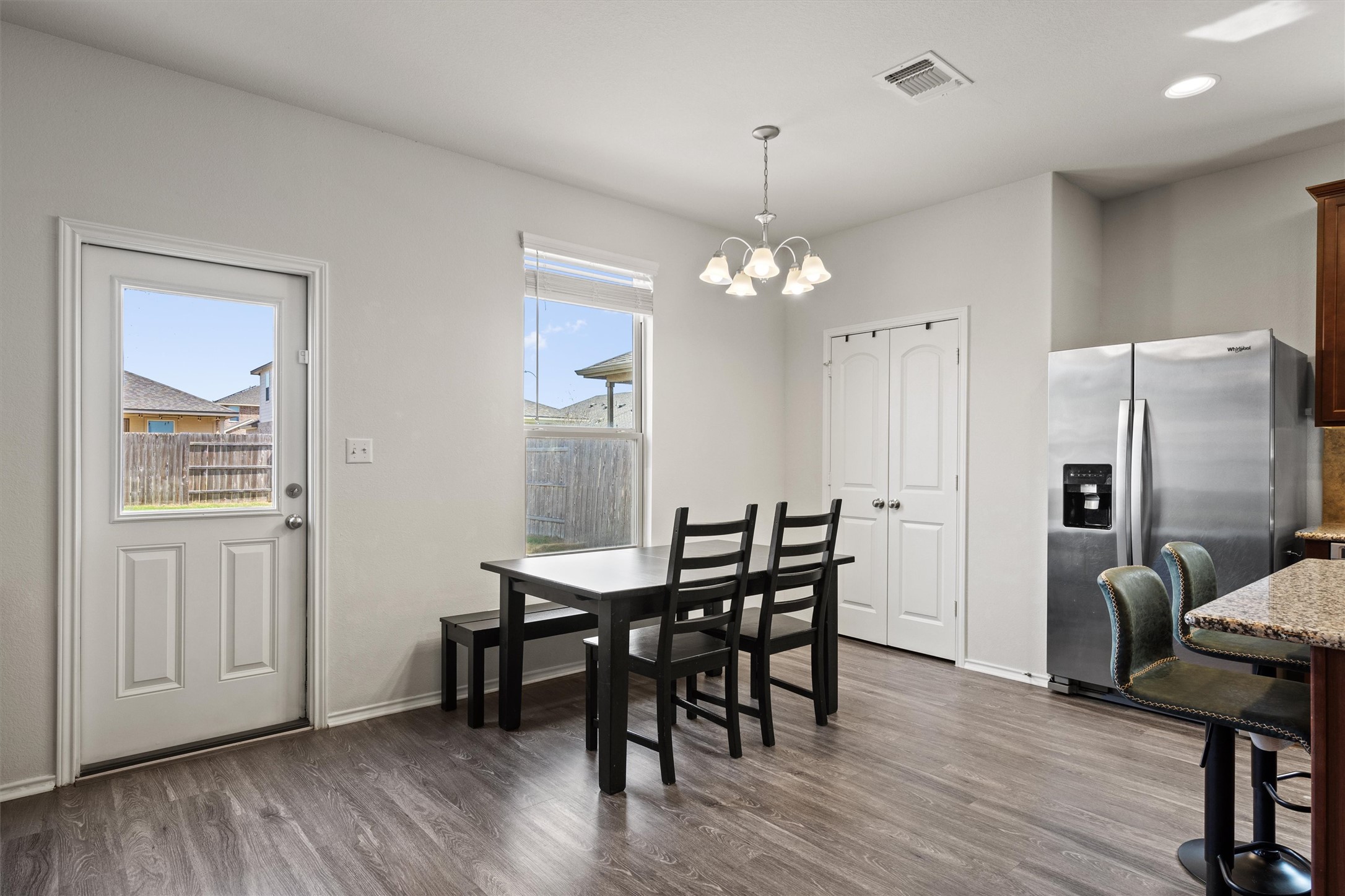 11816 Jackson Fls Way Manor, TX 78653 - Photo 11 of 40 a view of a dining room with furniture and wooden floor
