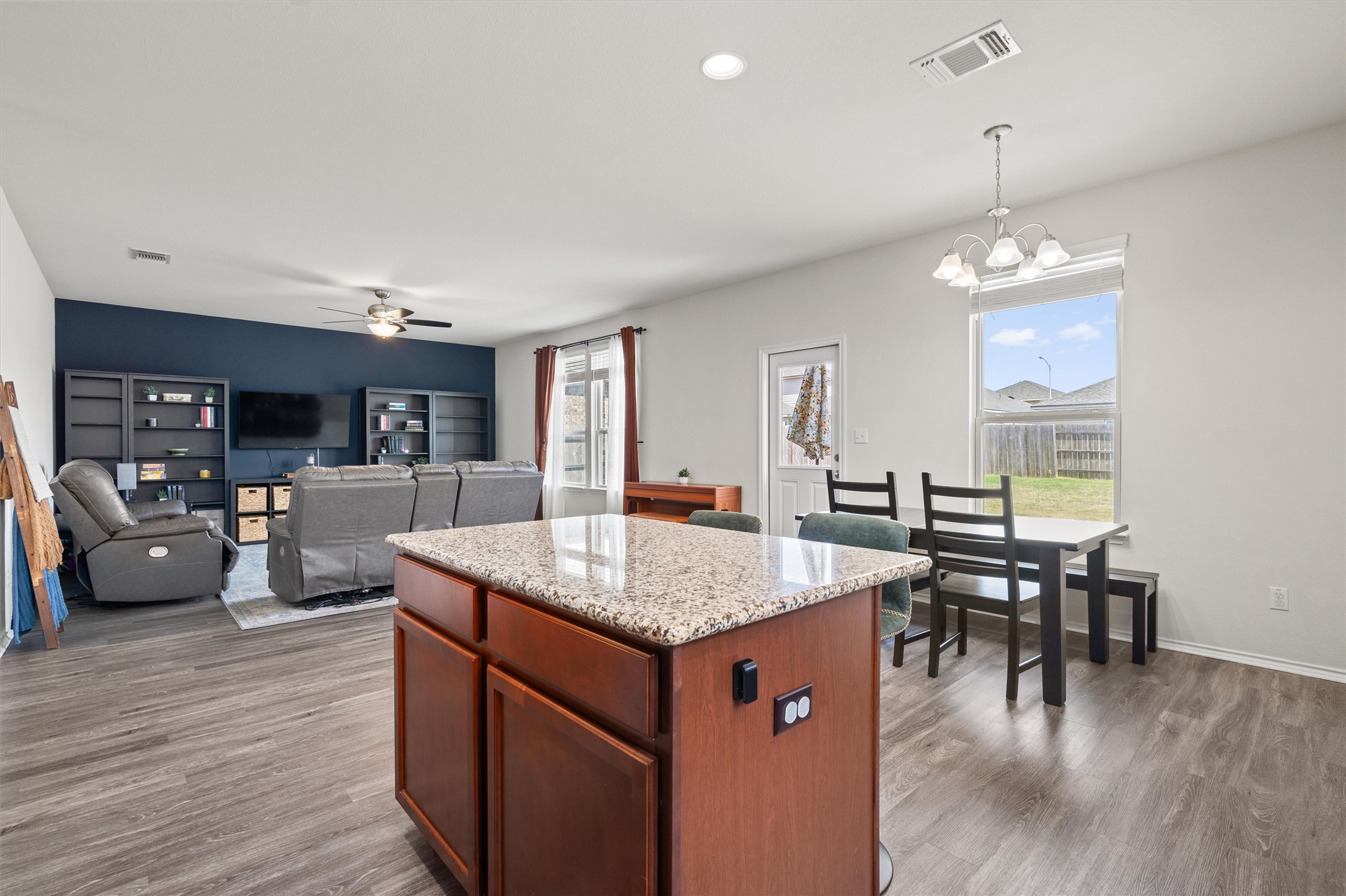 11816 Jackson Fls Way Manor, TX 78653 - Photo 38 of 40 a kitchen with center island table and chairs