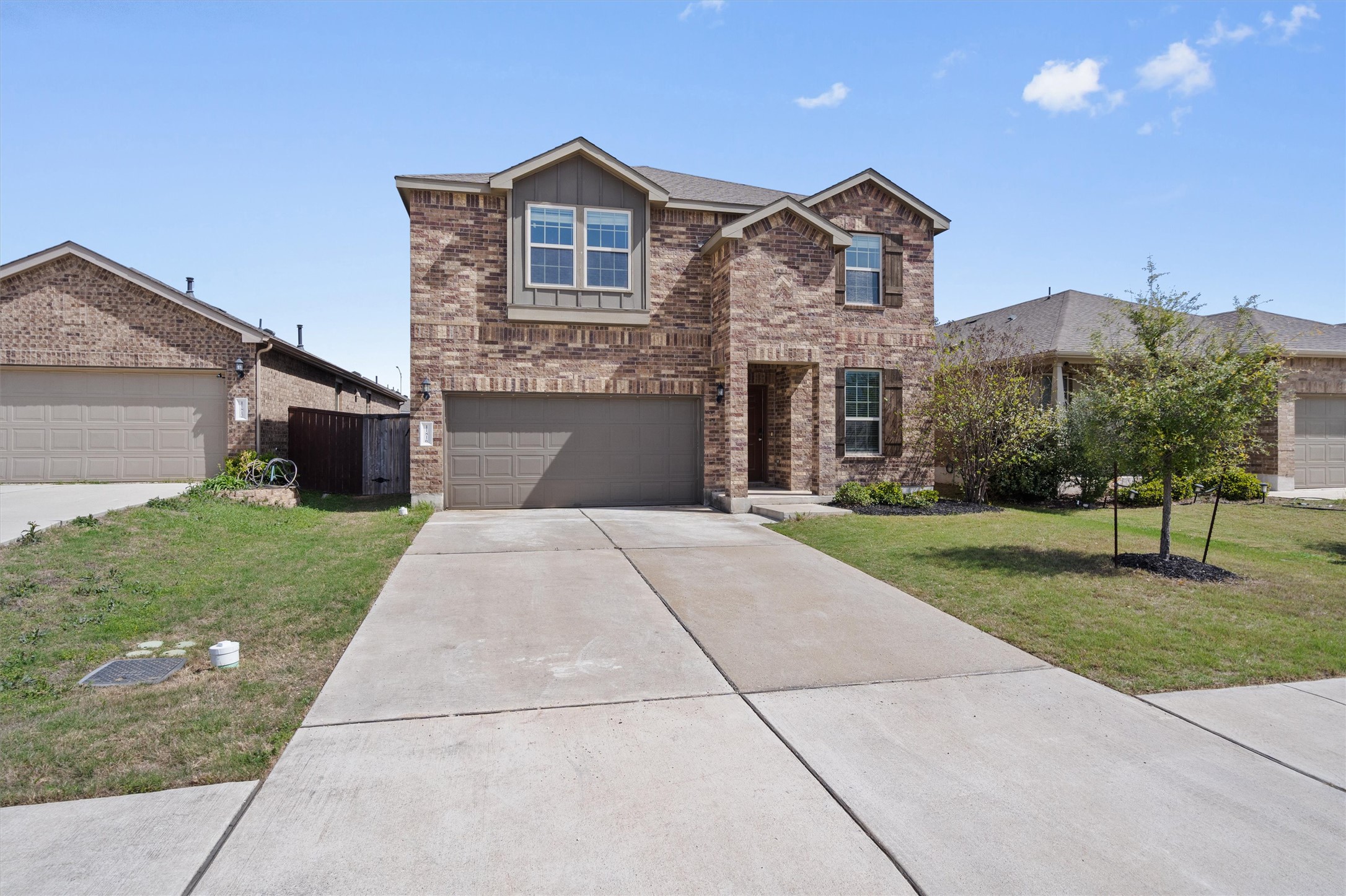 11816 Jackson Fls Way Manor, TX 78653 - Photo 2 of 40 a front view of a house with a yard and garage