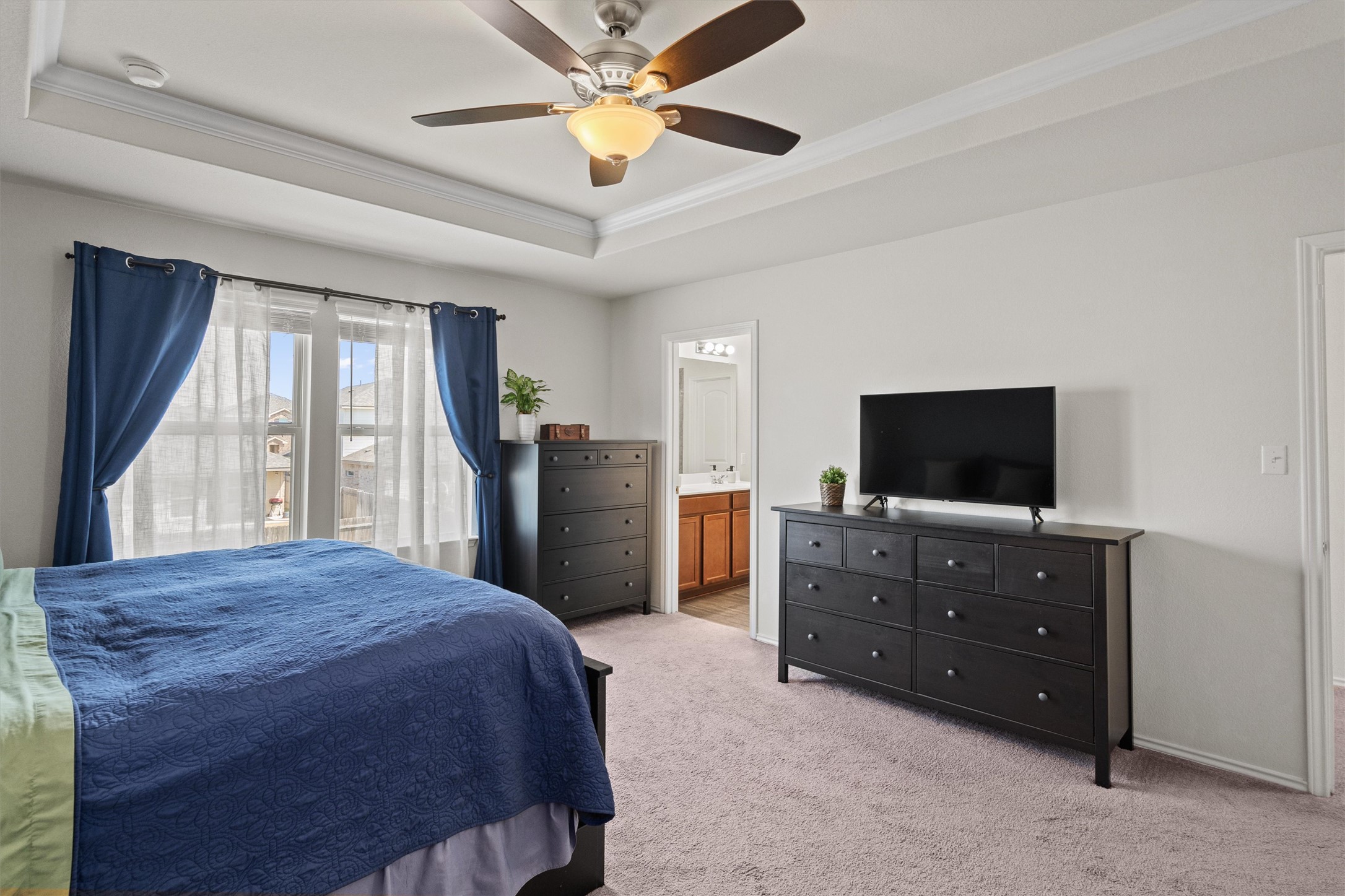 11816 Jackson Fls Way Manor, TX 78653 - Photo 25 of 40 a bedroom with a bed and a flat screen television