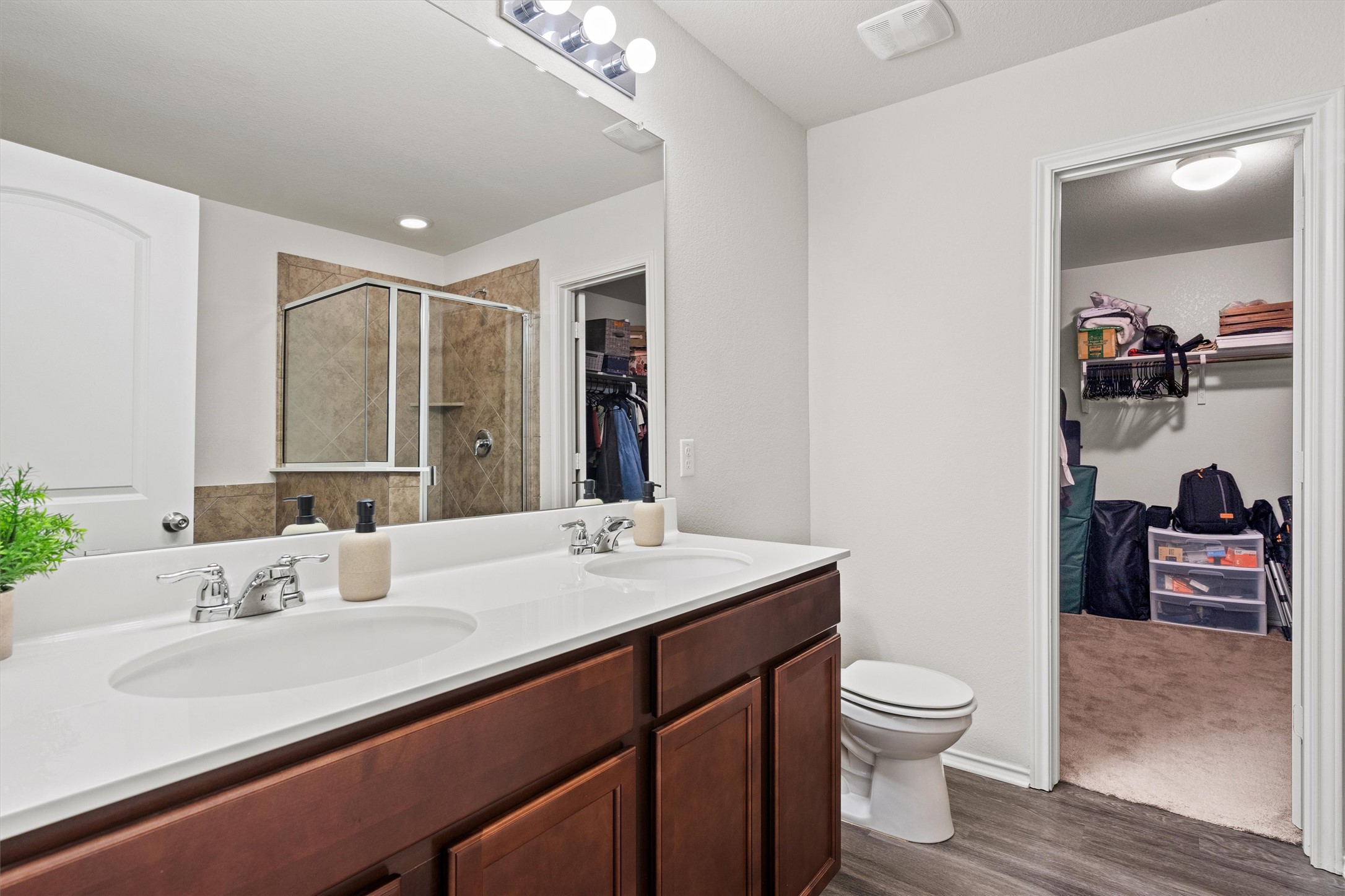 11816 Jackson Fls Way Manor, TX 78653 - Photo 26 of 40 a bathroom with a sink a toilet and a large mirror