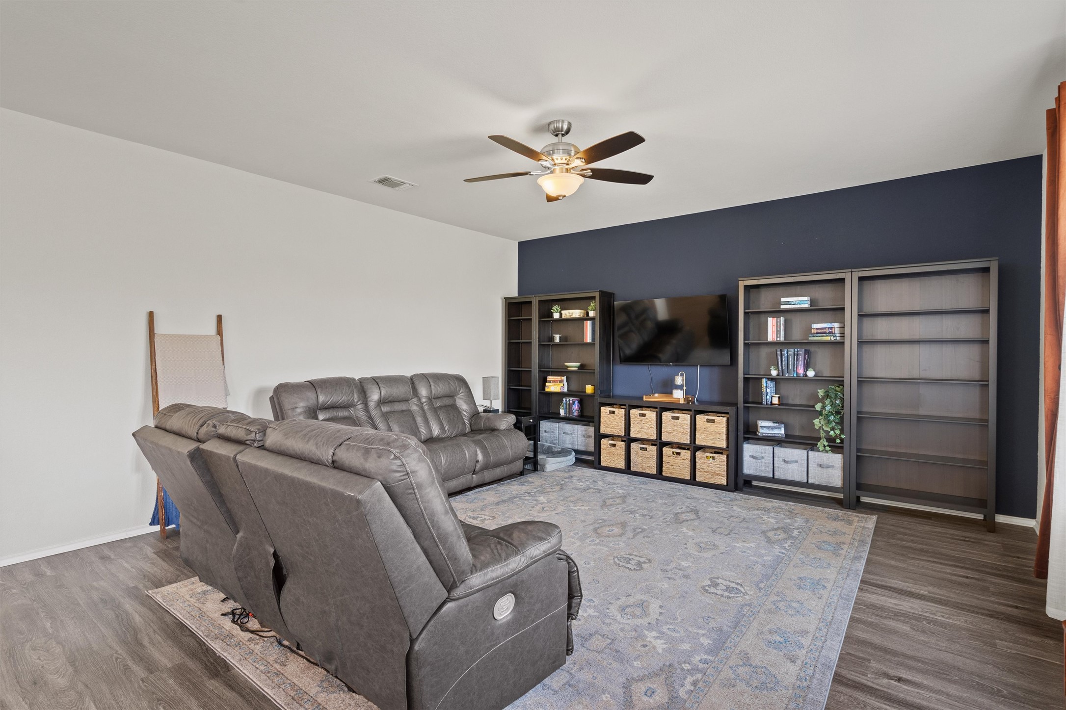 11816 Jackson Fls Way Manor, TX 78653 - Photo 9 of 40 a living room with furniture a ceiling fan and a wooden floor