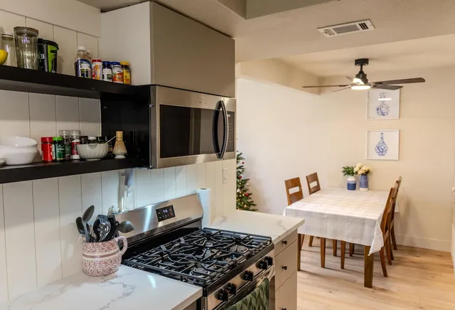 a kitchen with a stove and a refrigerator