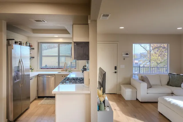 a living room with furniture and a kitchen