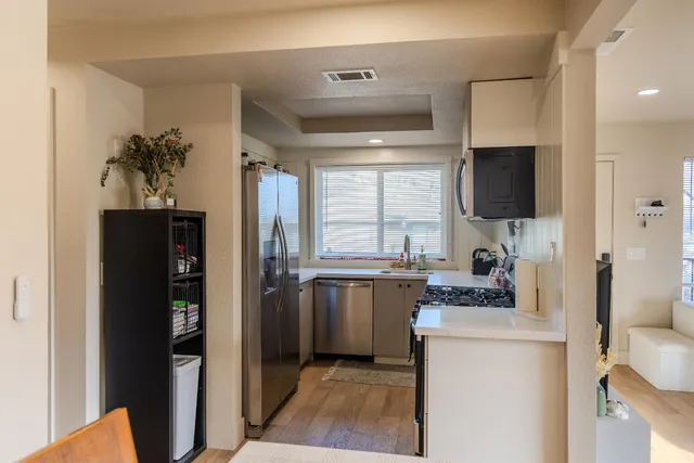 a kitchen with a refrigerator and a stove top oven