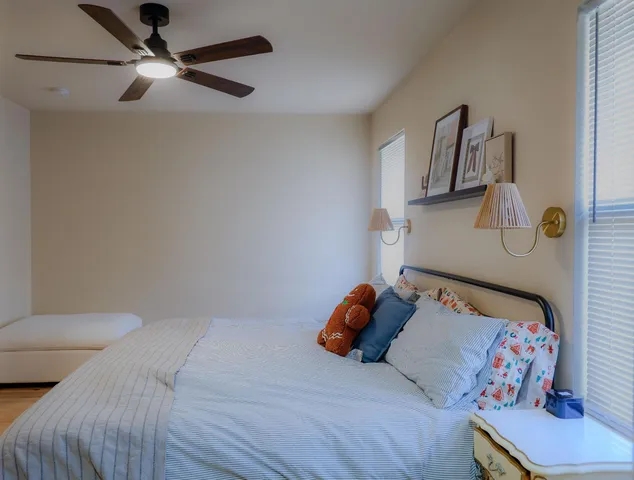 a bedroom with a bed and a window