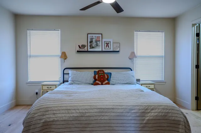 a bedroom with a bed and a chandelier