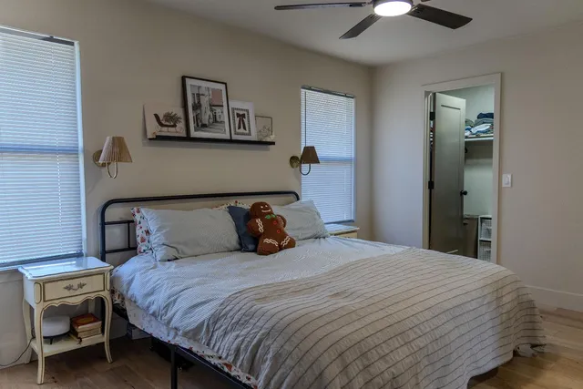 a bedroom with a bed and a chandelier