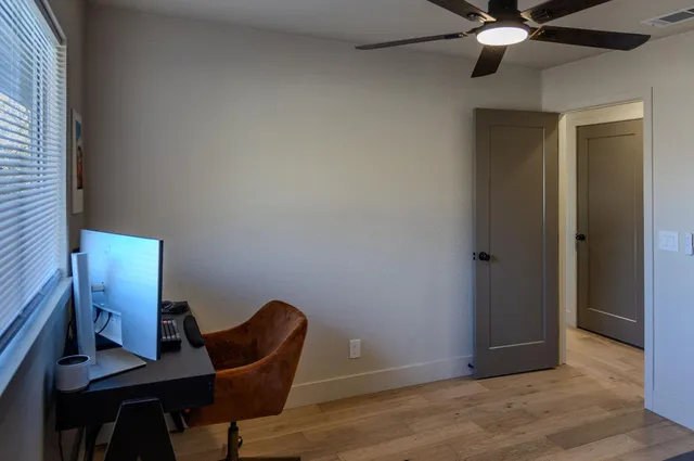 a workspace with furniture and wooden floor
