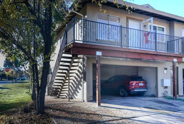 a view of a porch with wooden floor and a fireplace