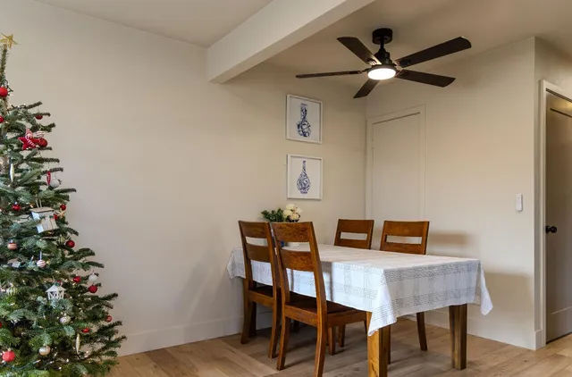 a view of a room with a table and chairs