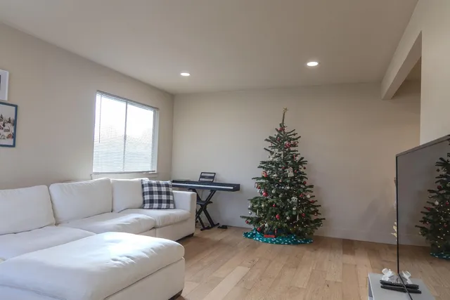 a living room with furniture and a christmas tree