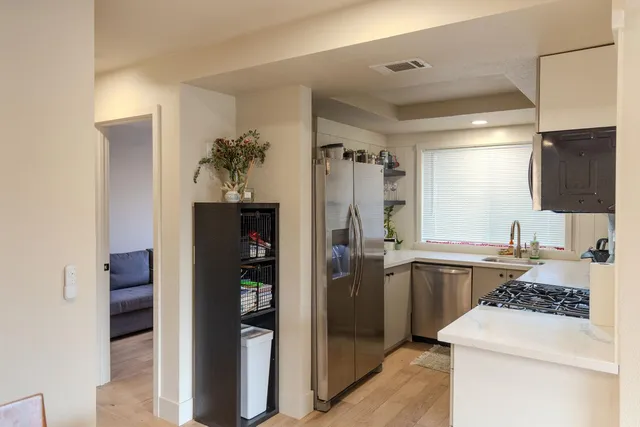 a kitchen with a refrigerator and a sink