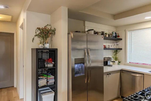 a kitchen with stainless steel appliances a refrigerator and a counter top space