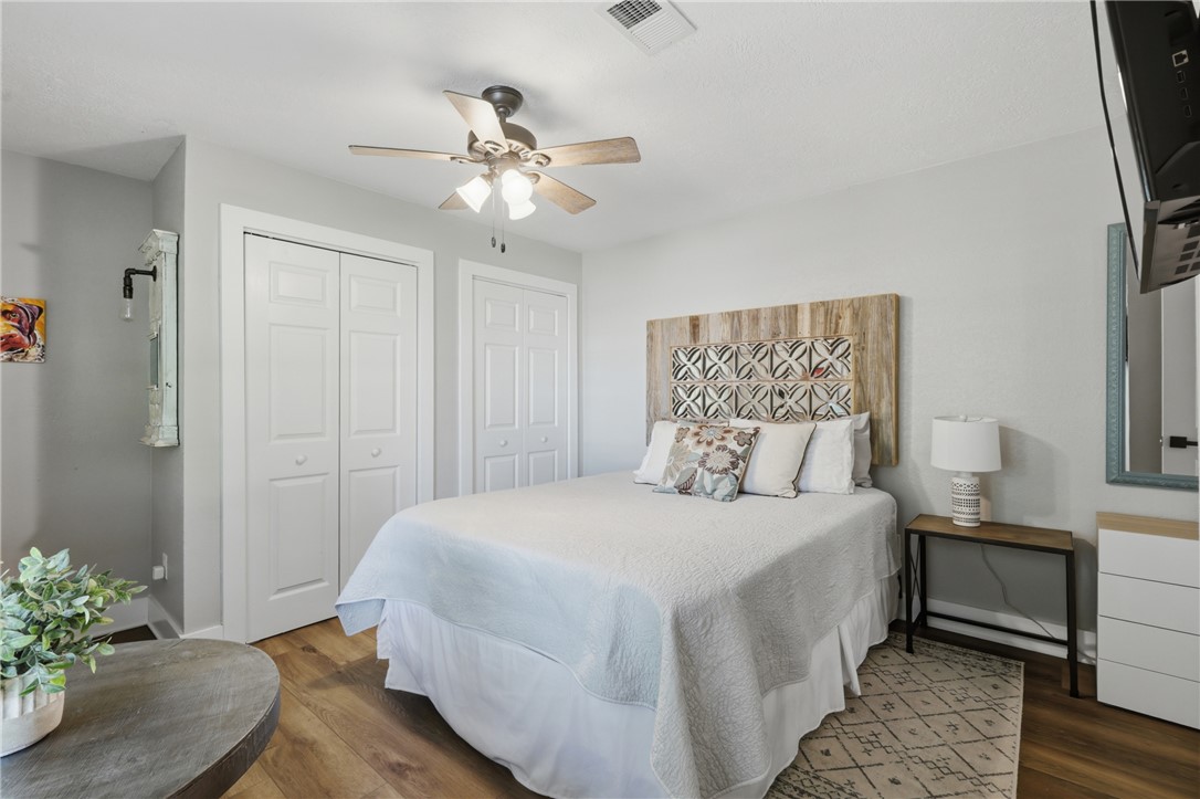 515 Crescent Drive Bryan, TX 77801 - Photo 28 of 43 Room featuring wood-look LVP flooring, two white panel doors, and a ceiling fan with light fixture