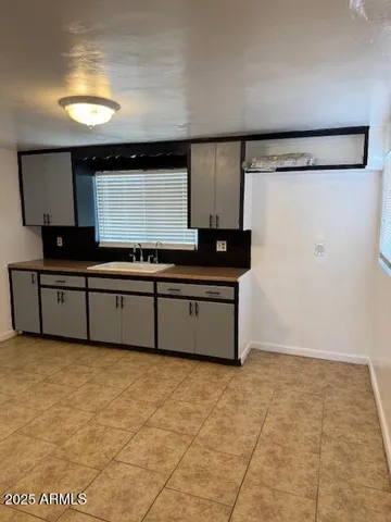 a kitchen with stainless steel appliances a sink and a refrigerator