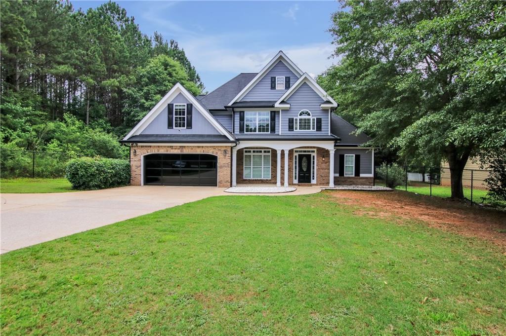1302 Sleepy Hollow Road Powder Springs, GA 30127 - Photo 1 of 1 a front view of a house with a garden
