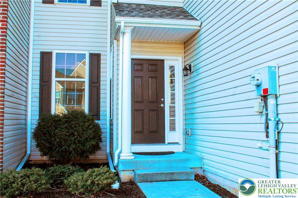 5392 Spring Ridge Drive West Lower Macungie Township, PA 18062 - Photo 2 of 17 a front view of a house with a yard