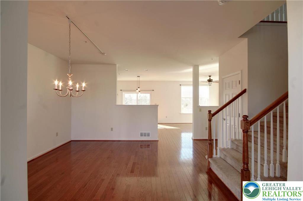 5392 Spring Ridge Drive West Lower Macungie Township, PA 18062 - Photo 3 of 17 a view of a hallway with wooden floor and staircase
