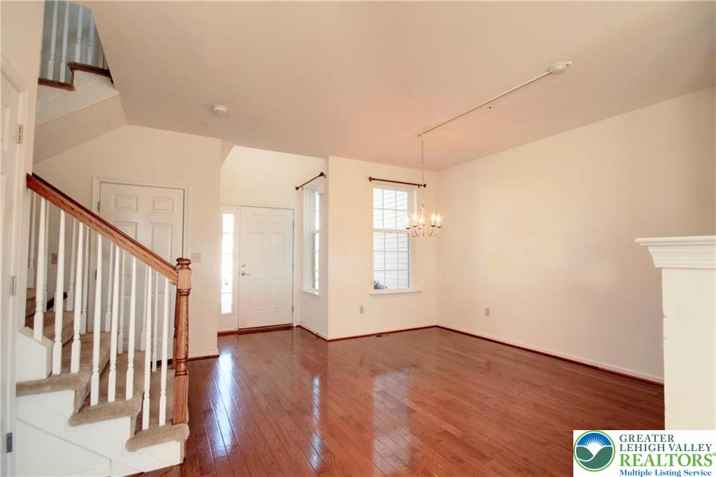 5392 Spring Ridge Drive West Lower Macungie Township, PA 18062 - Photo 4 of 17 an empty room with wooden floor and windows