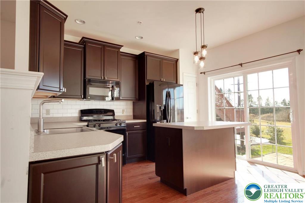 5392 Spring Ridge Drive West Lower Macungie Township, PA 18062 - Photo 5 of 17 a kitchen with stainless steel appliances granite countertop a refrigerator a sink a stove and a refrigerator