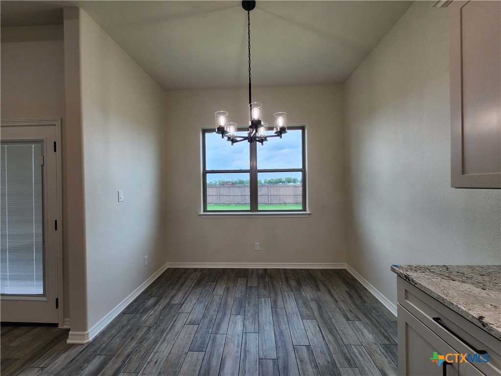 406 Talon Loop Salado, TX 76571 - Photo 10 of 31 a view of a room with wooden floor chandelier and window