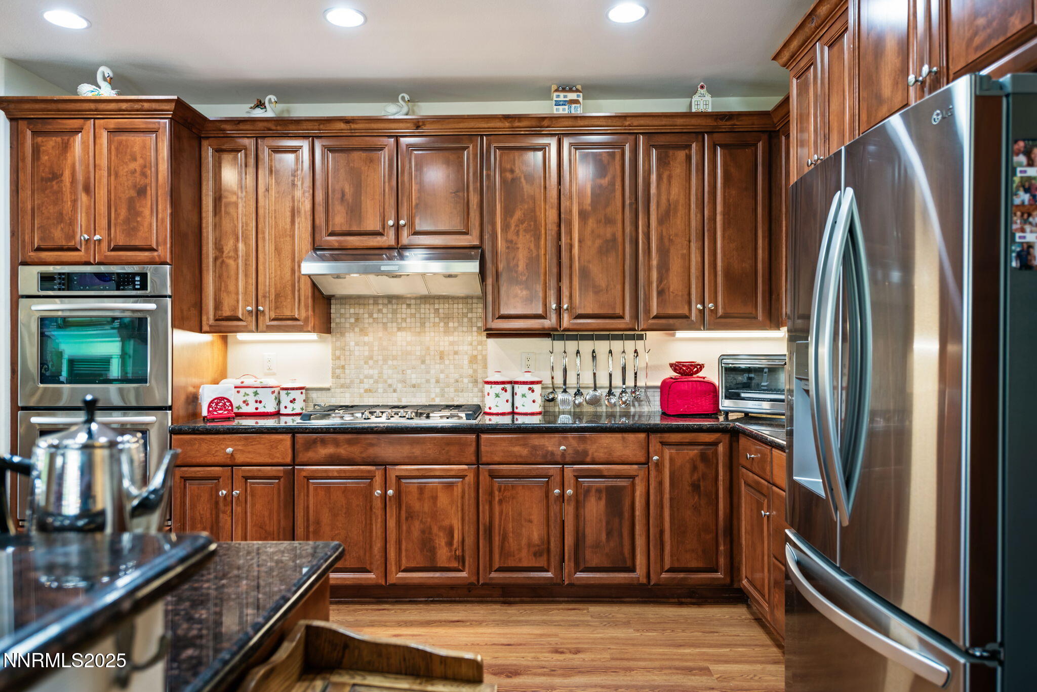 112 Eagle Brook Lane Dayton, NV 89403 - Photo 23 of 48 a kitchen with stainless steel appliances granite countertop a refrigerator and stove