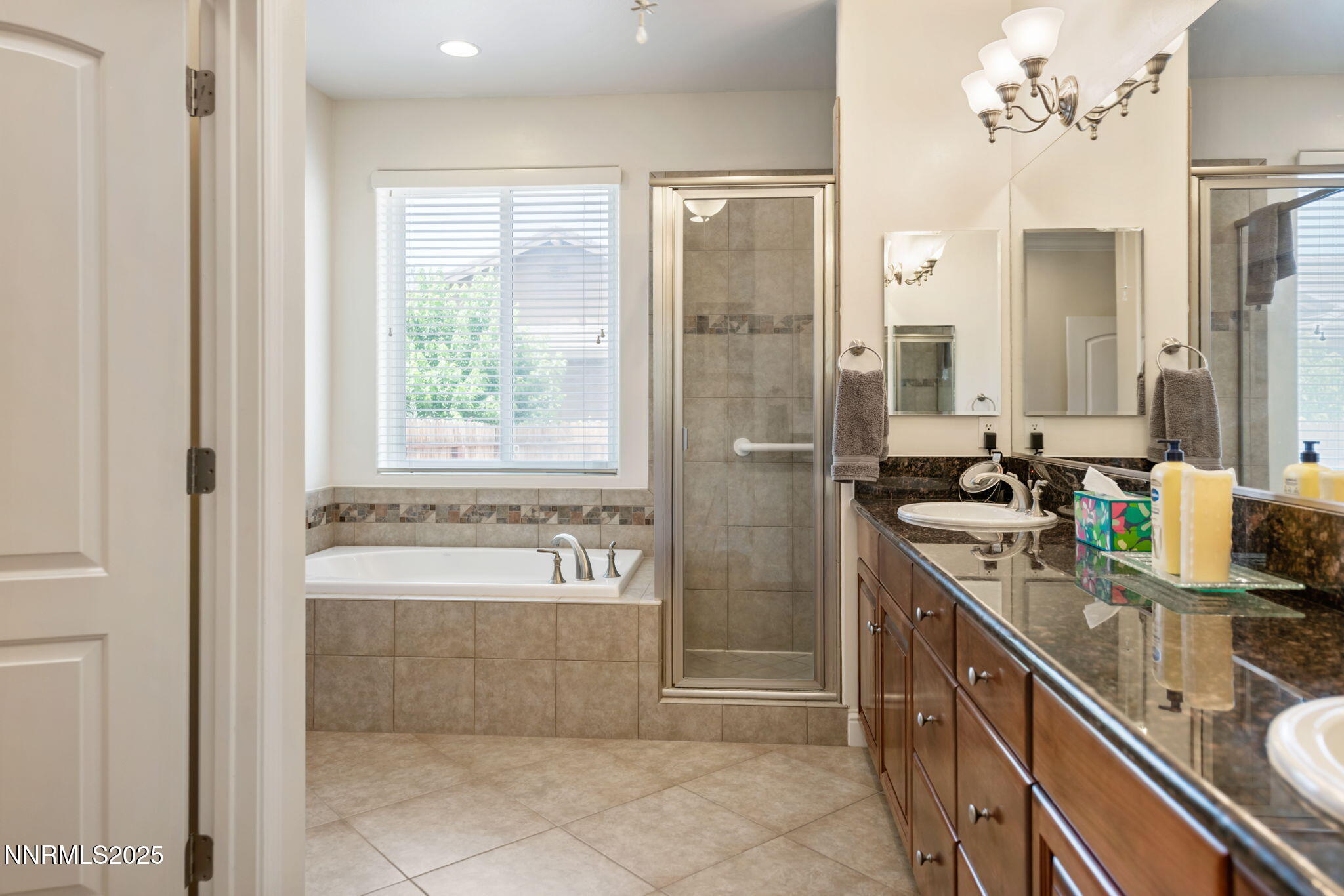 112 Eagle Brook Lane Dayton, NV 89403 - Photo 29 of 48 a spacious bathroom with a double vanity sink a mirror and a bathtub