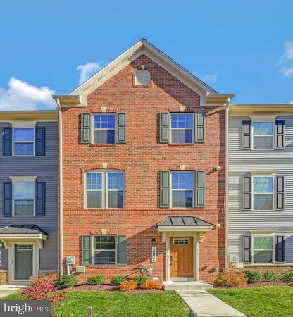 a front view of residential houses with yard