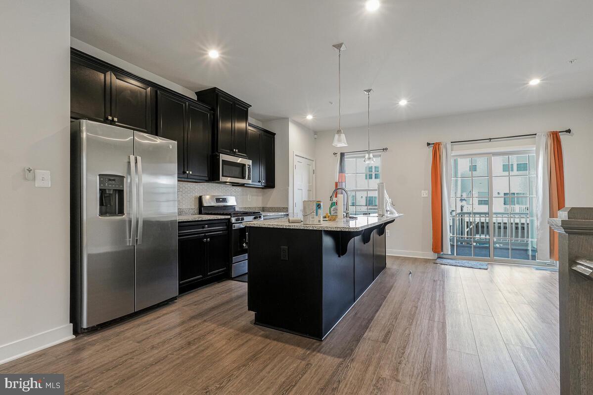 14934 Ring House Road Brandywine, MD 20613 - Photo 11 of 34 a large kitchen with a large center island and wooden floor