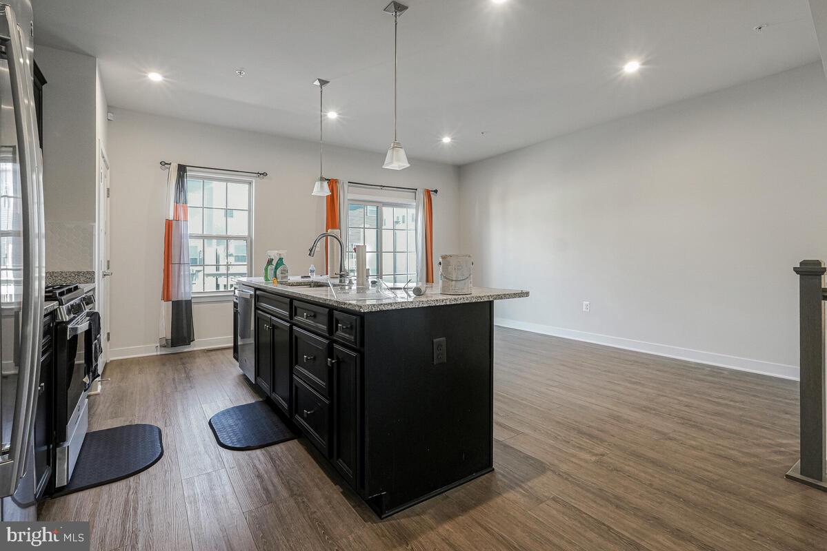 14934 Ring House Road Brandywine, MD 20613 - Photo 13 of 34 a kitchen with stainless steel appliances granite countertop a sink cabinets and wooden floor