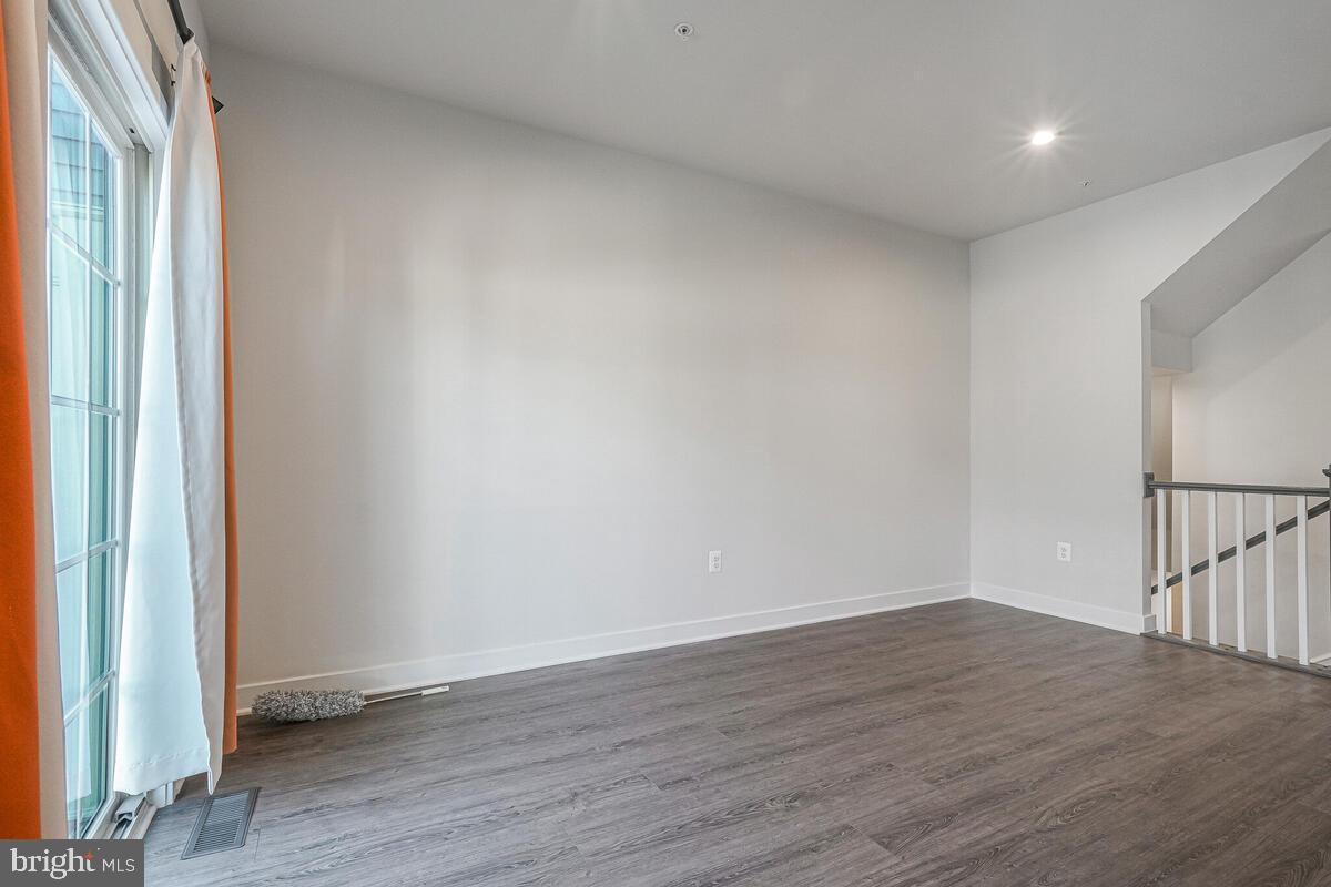 14934 Ring House Road Brandywine, MD 20613 - Photo 14 of 34 a view of an empty room with wooden floor and a window