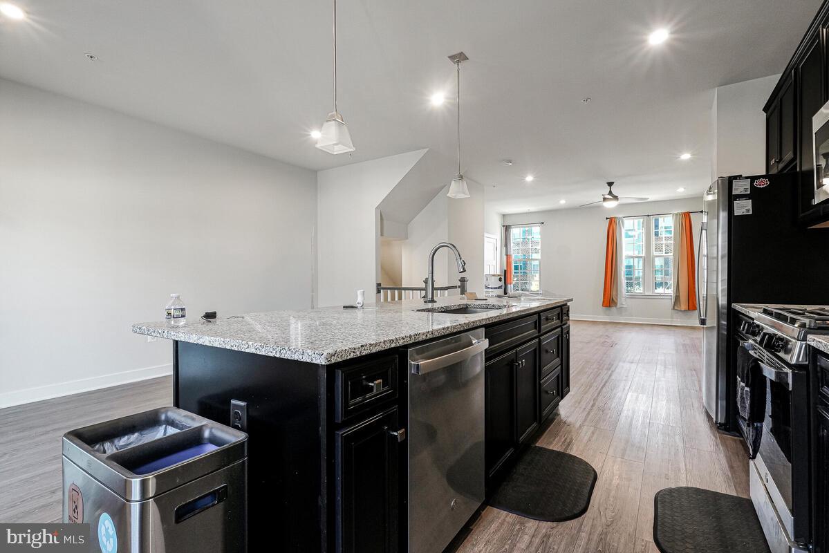 14934 Ring House Road Brandywine, MD 20613 - Photo 17 of 34 a kitchen with granite countertop a sink a counter top space stainless steel appliances and cabinets