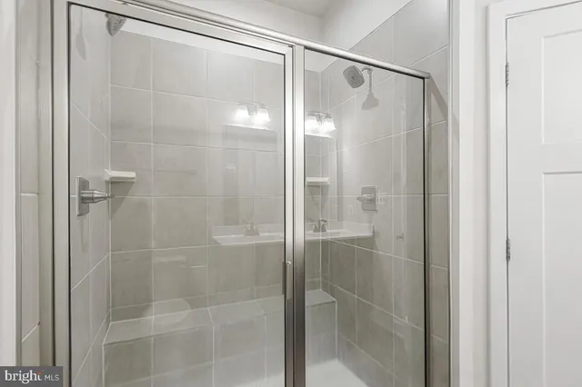 a bathroom with a glass shower door