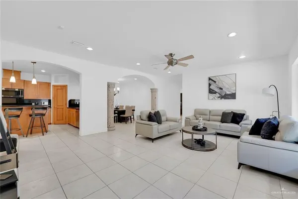 a living room with furniture and kitchen view