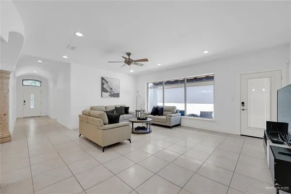 a living room with furniture and a chandelier