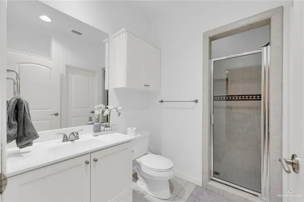 a bathroom with a toilet sink and shower