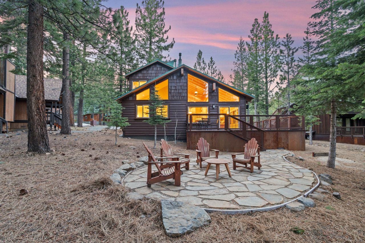 a view of a patio with a dining table and chairs with wooden fence