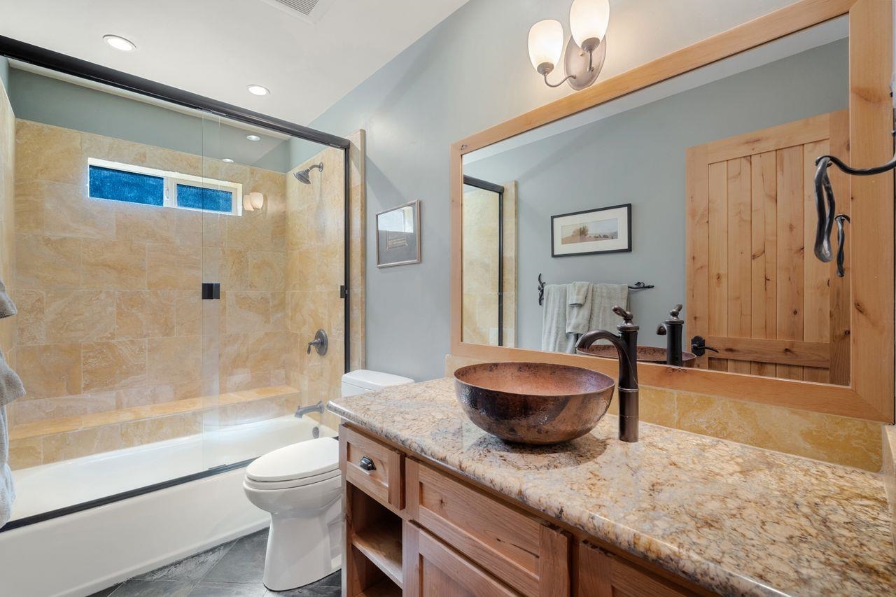 13456 Ski View Loop Truckee, CA 96161 - Photo 11 of 24 a bathroom with a granite countertop sink and a mirror