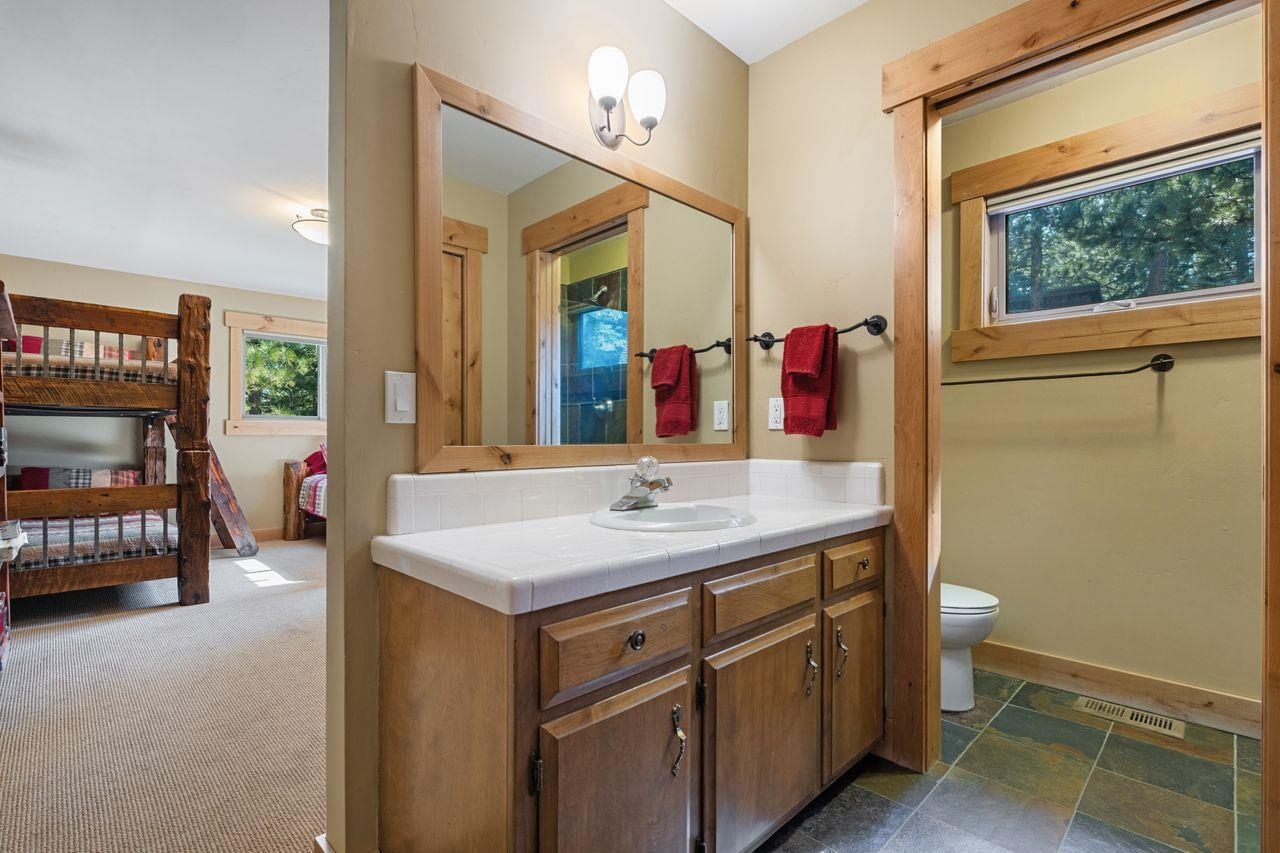 13456 Ski View Loop Truckee, CA 96161 - Photo 14 of 24 a bathroom with a granite countertop sink and a large mirror