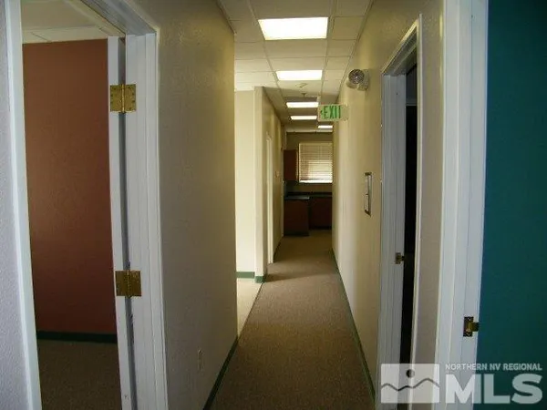 a view of a hallway with a bathroom