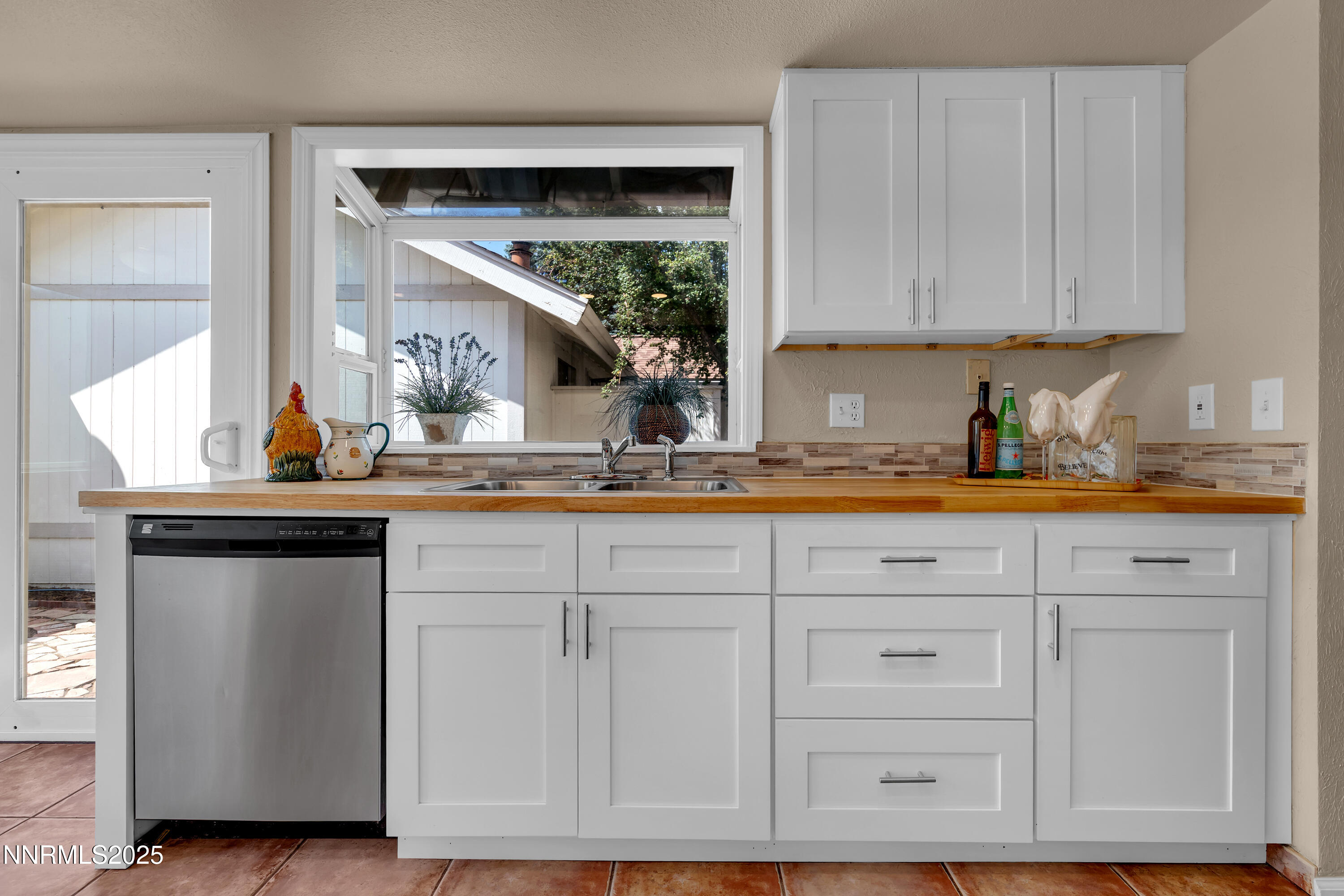 1265 Searchlite Court Reno, NV 89503 - Photo 15 of 43 a kitchen with white cabinets and sink