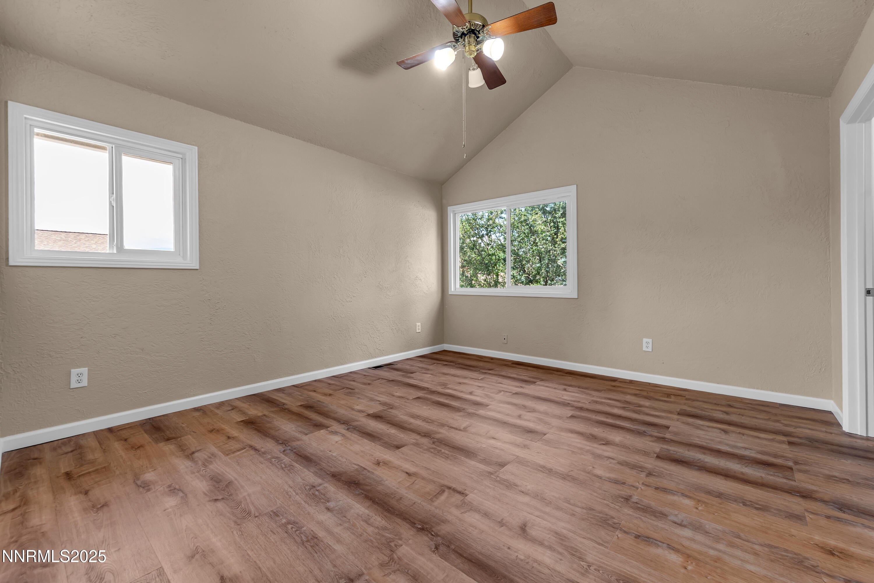 1265 Searchlite Court Reno, NV 89503 - Photo 18 of 43 a view of an empty room with wooden floor and a window