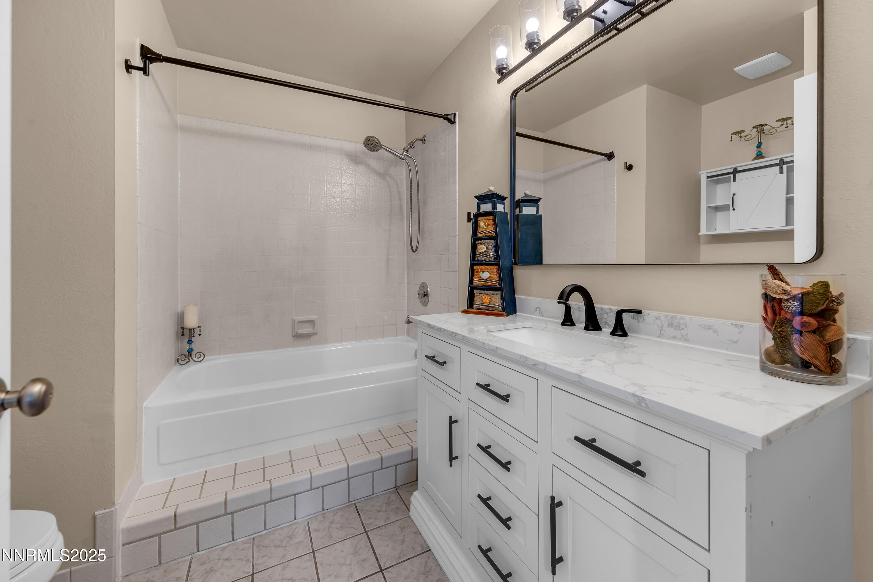 1265 Searchlite Court Reno, NV 89503 - Photo 21 of 43 a bathroom with a tub sink toilet and a mirror