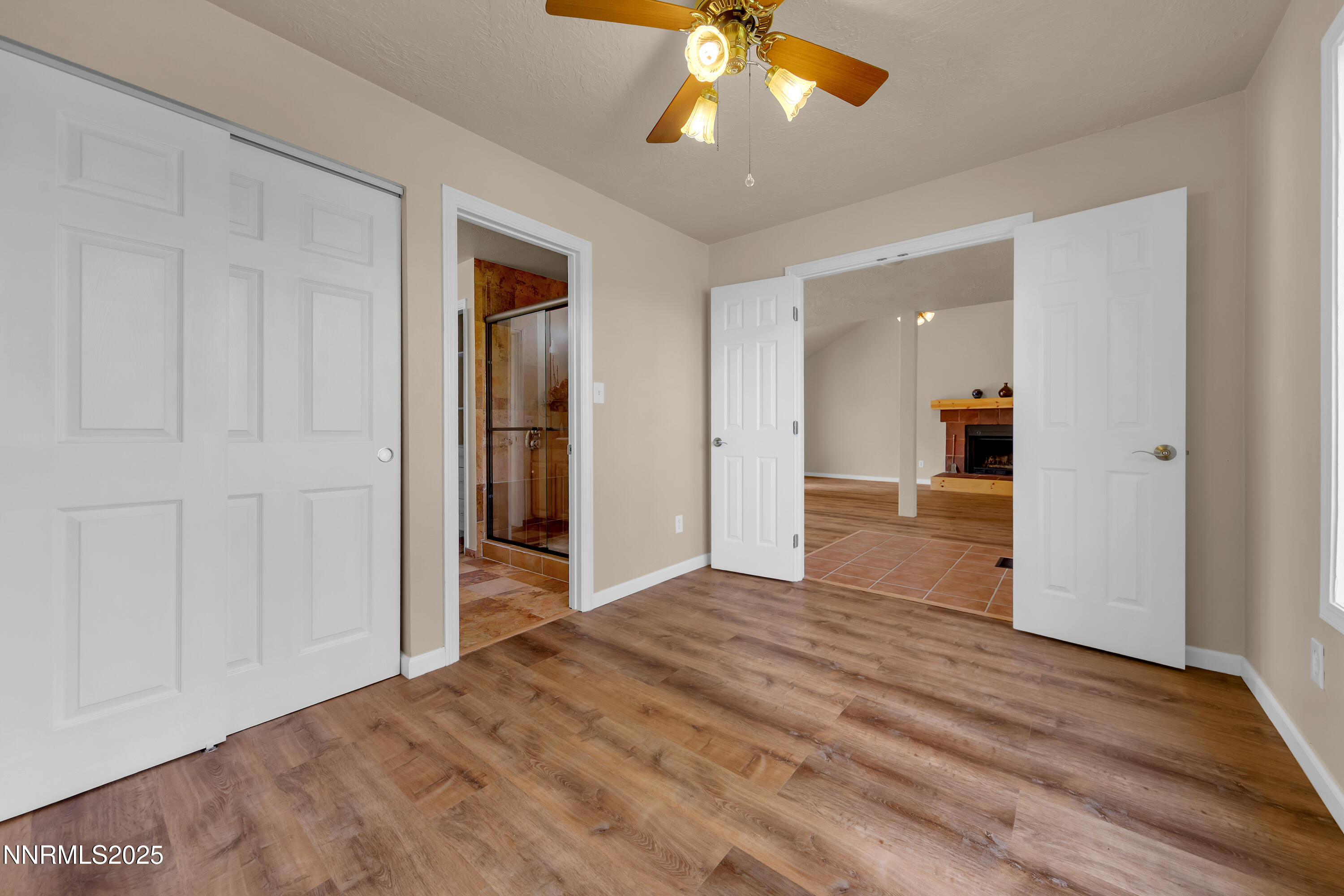 1265 Searchlite Court Reno, NV 89503 - Photo 28 of 43 a view of an empty room with wooden floor and a ceiling fan