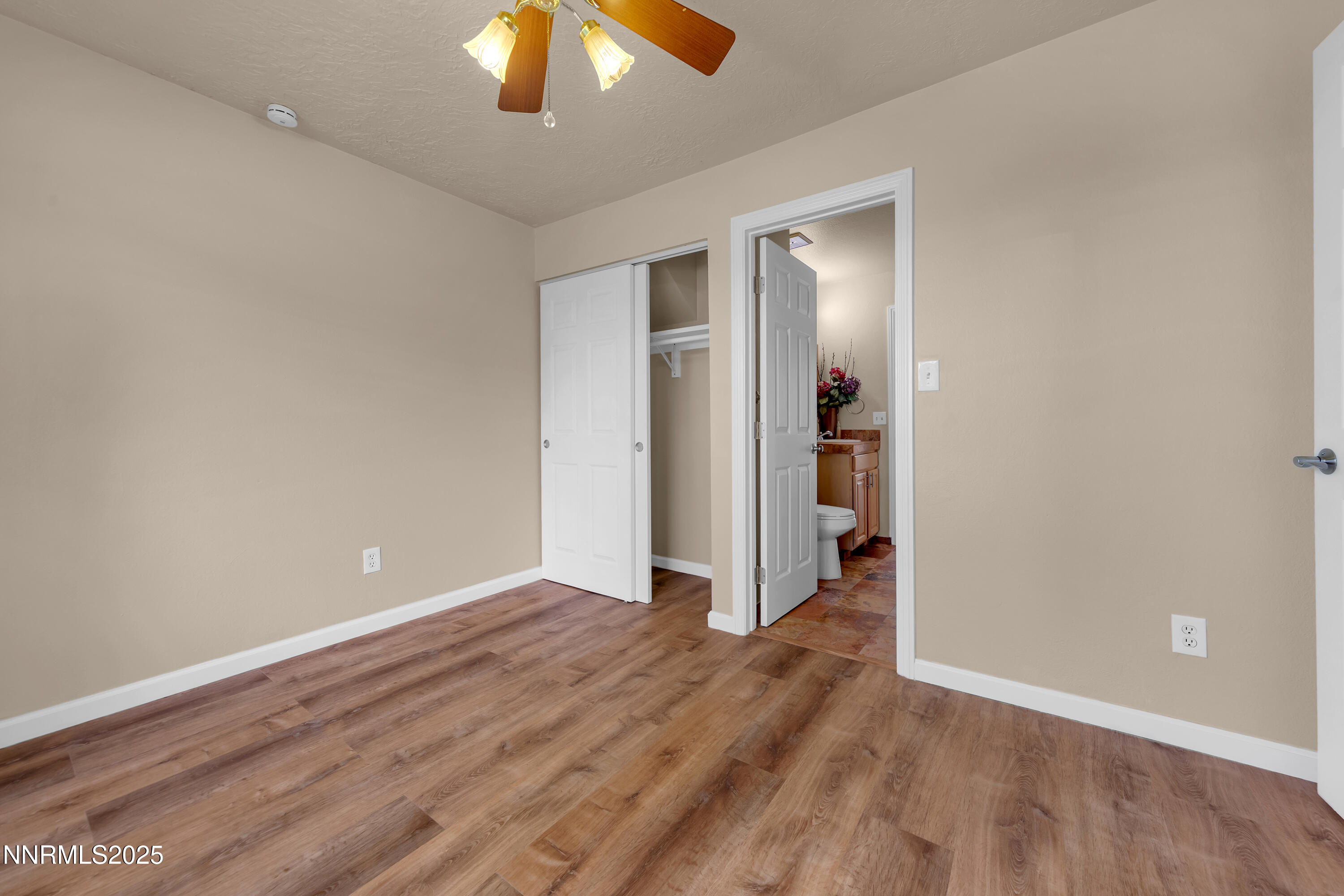 1265 Searchlite Court Reno, NV 89503 - Photo 29 of 43 a view of an empty room with wooden floor and a ceiling fan